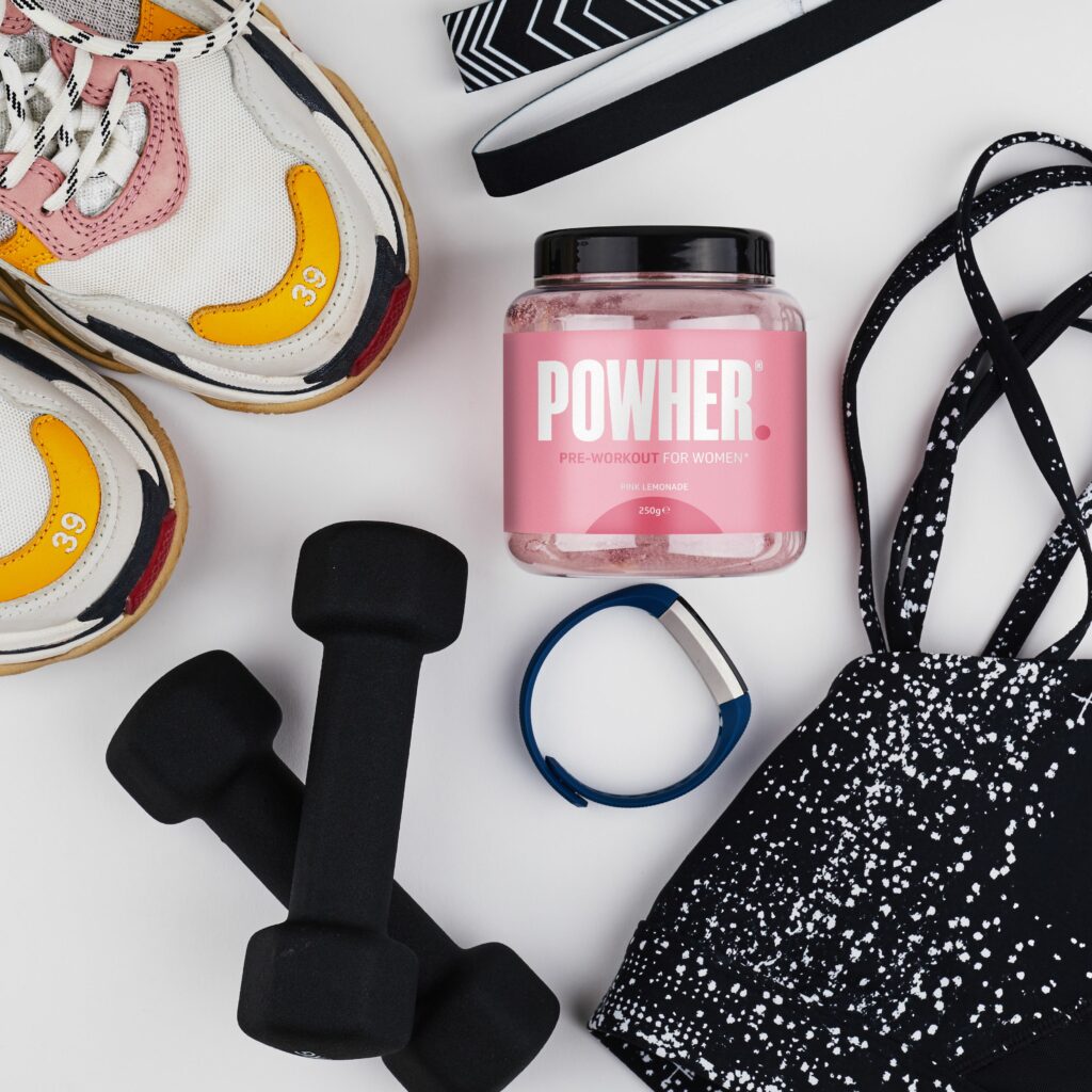 Powher pre-workout product alongside gym equipment